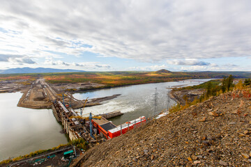 Fototapeta na wymiar Panoramic view of the Ust-Srednekanskaya hydroelectric power station in the autumn season