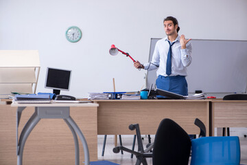 Young male employee unhappy with excessive work
