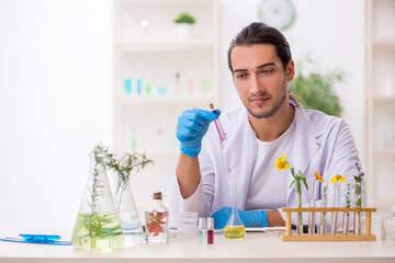 Young male chemist in perfume synthesis concept