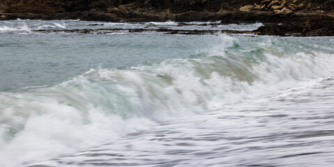 Wave Breaking onto sea shore beach