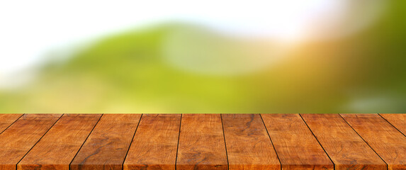 Wooden shelf is blank template with natural green mountain and tree blur bokeh and sun light...