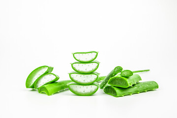 Pile of fresh aloe vera plant slices stacked and aloe vera stalk or leaves with water dropping isolate on white background.