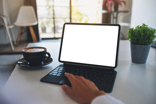 Mockup image of a business woman using and touching on tablet touchpad with blank white desktop screen as a computer pc