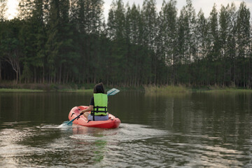 Fototapeta na wymiar Rear woman kayaking on lake