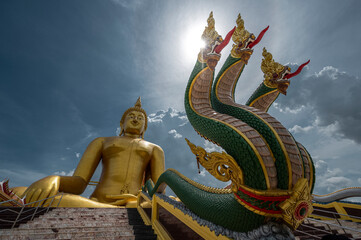 Fototapeta premium The status of king of Nagas stairway on the front of Big golden buddha in Wat muang temple, Landmark of Angthong, Angthong province, Thailand 