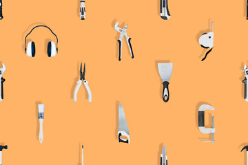 Tools seamless pattern. Various construction tools on an orange background.