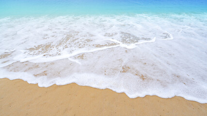 Beautiful sea summer or beach and tropical sea background,soft turquoise ocean wave crashing on sandy shore in summer season sunny day,Nature and travel background concept