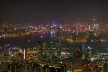 Fototapeta na wymiar Victoria Harbour with Hong Kong Island and Kowloon visible in the distance from the top of Kowloon peak during the night hike