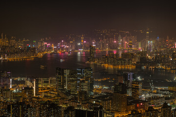 Fototapeta na wymiar Victoria Harbour with Hong Kong Island visible in the distance as seen from the top of Kowloon peak in the night. 