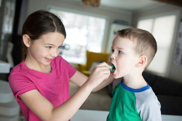sister helps little brother