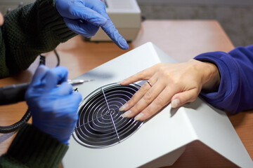 In the salon master of manicure nail extension treatment of the nail plate.