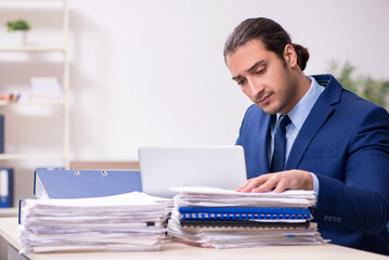 Young male employee unhappy with excessive work