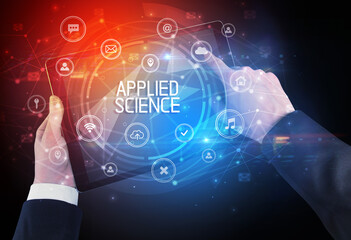 Close-up of a tablet with APPLIED SCIENCE inscription, innovative technology concept