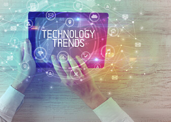 Close-up of a tablet with TECHNOLOGY TRENDS inscription, innovative technology concept
