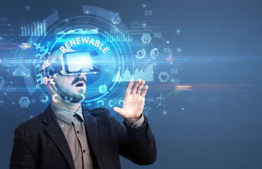 Businessman looking through Virtual Reality glasses with RENEWABLE inscription, innovative technology concept