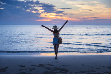 Fototapeta na wymiar Traveler asian woman travel on Sai Khao Beach at sunset in Koh Chang Trad Thailand