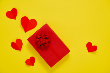 Gift Box and Paper red hearts on a yellow