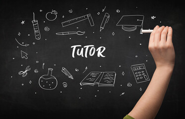 Hand drawing TUTOR inscription with white chalk on blackboard, education concept