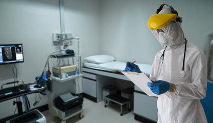 Naklejka premium Orthopedic Control room, Doctors in PPE protective clothing inspect the orthopedic operating control room. To protect patients infected with the coronavirus COVID-19 