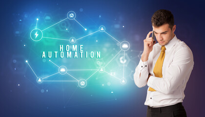 Businessman in front of cloud service icons with HOME AUTOMATION inscription, modern technology concept