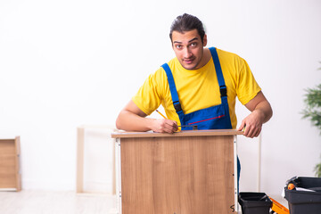 Young male carpenter working indoors