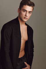 Obraz premium Cute young guy fashionable hairstyle black shirt posing attractive look