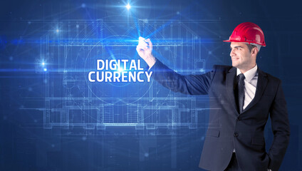 Handsome architect with helmet drawing DIGITAL CURRENCY inscription, new technology concept