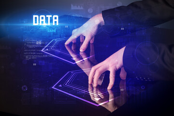 Hand touching digital table with DATA inscription, new age security concept