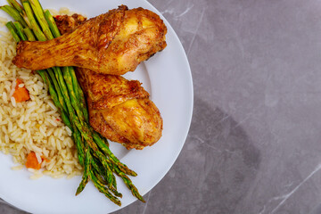 Roasted turkey drumsticks with rice on rustic wooden background,