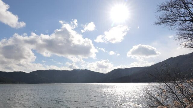 Lake Yogo in Shiga Prefecture in winter, the surface of the pond illuminated by the strong sunlight.