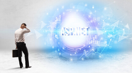 Rear view of a businessman standing in front of ASP.NET inscription, modern technology concept