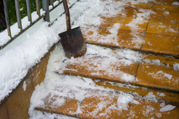 Fototapeta premium removing ice from tiled steps