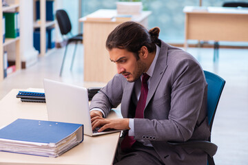 Young male employee working in the office