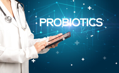 Doctor fills out medical record with PROBIOTICS inscription, medical concept