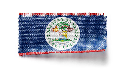 Belize flag on a piece of cloth on a white background