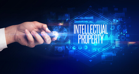 hand holding wireless peripheral with INTELLECTUAL PROPERTY inscription, cyber security concept