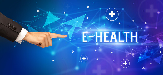 Close-Up of cropped hand pointing at E-HEALTH inscription, medical concept