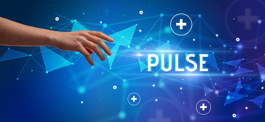 Close-Up of cropped hand pointing at PULSE inscription, medical concept