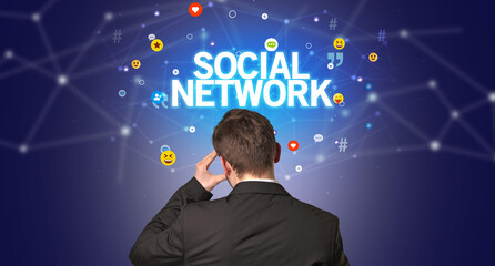 Rear view of a businessman with SOCIAL NETWORK inscription, social networking concept