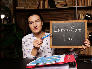 Business concept about Lump-Sum Tax with inscription on black chalkboard.