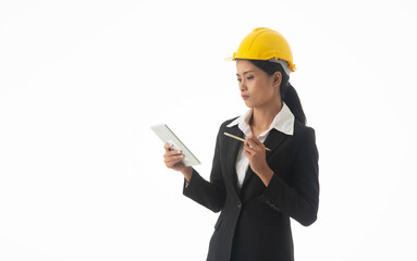 Young engineer woman wear black suit and yellow safety helmet holding note or tablet on isolated white background.
