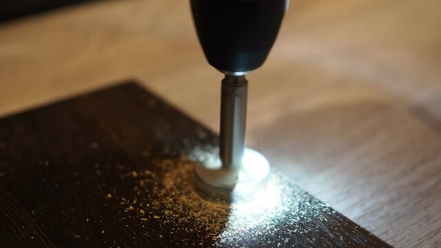 a screwdriver with a drill for the hinge holes. drill the door. making a kitchen.