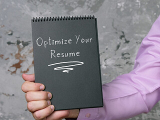 Motivational concept about Optimize Your Resume with sign on the page.