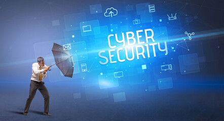 Businessman defending with umbrella from cyber attack and CYBER SECURITY inscription, online security concept