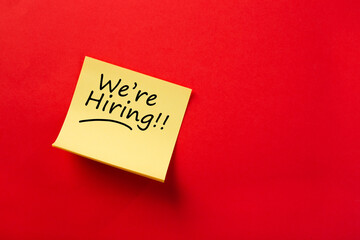 Sticky note with We're hiring on red background
