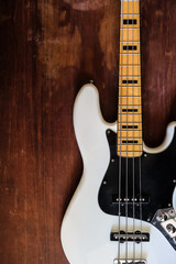 Fototapeta na wymiar white electric bass guitar on wood background with copy space