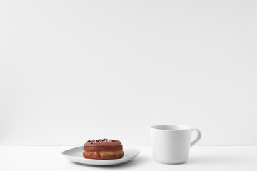 Mug and donuts cakes on a white background. Confectionery, coffee shop. Copy space, mock up.