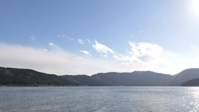 Nagahama, Shiga Prefecture, on a clear winter day, with blue sky and Lake Yogo shrouded in clouds.
