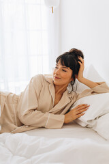 Woman resting on bed after waking up