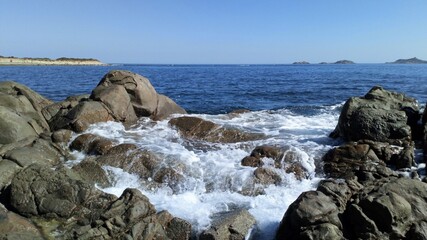Fototapeta na wymiar Waves on the rocks. Sardinia.